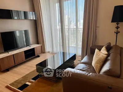 Modern living room with sleek furniture and city view from large windows.