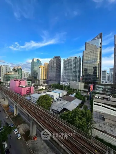 Stunning cityscape view with modern skyscrapers and railway, perfect for urban living enthusiasts.