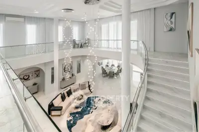 Luxurious two-story living room with elegant decor and modern furnishings