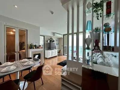 Stylish open-plan living and dining area with modern decor and balcony view