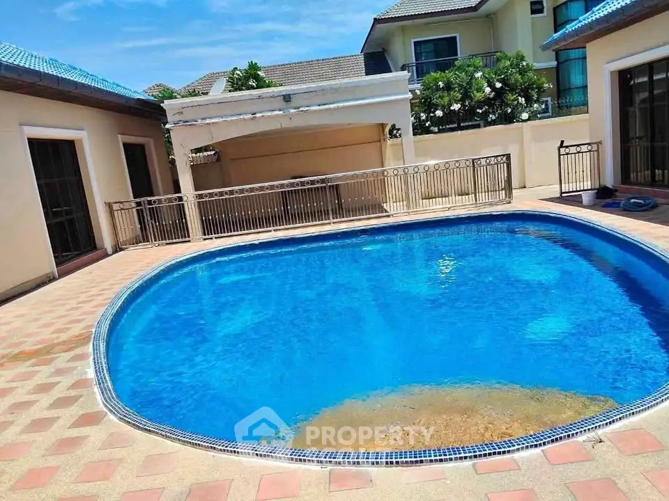 Luxurious private pool in a serene residential setting with elegant architecture and lush greenery.
