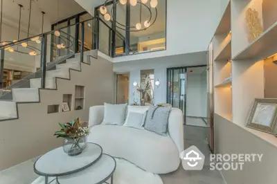 Luxurious modern living room with elegant staircase and stylish decor