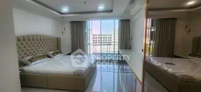 Luxurious bedroom with elegant decor and large windows offering natural light and a serene view.