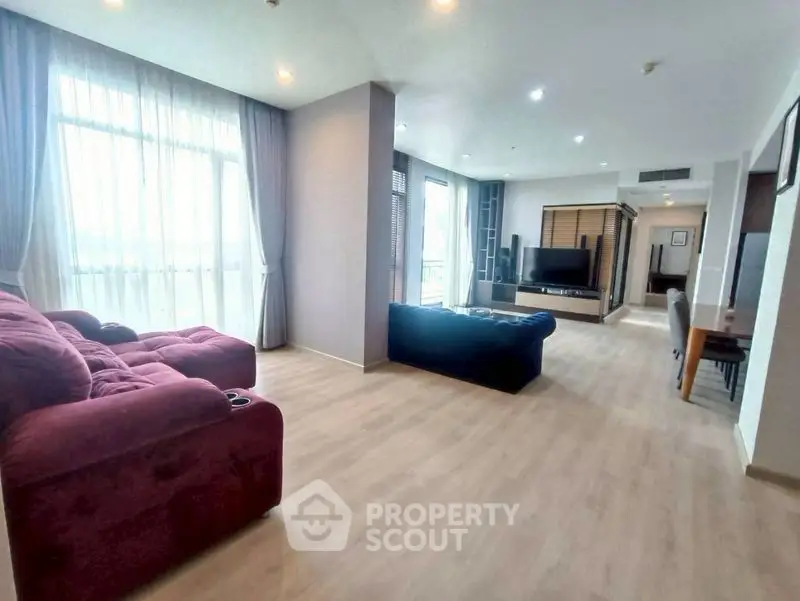 Spacious modern living room with large windows and stylish furniture