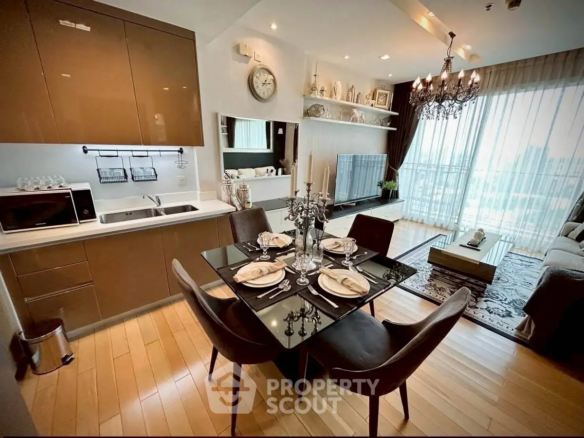 Luxurious open-plan living room with modern kitchen and elegant dining area, featuring floor-to-ceiling windows.