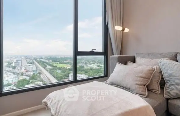 Luxurious living room with panoramic city view from high-rise window.