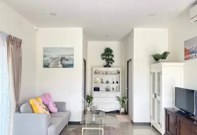 Charming living room with cozy sofa, modern decor, and natural light.