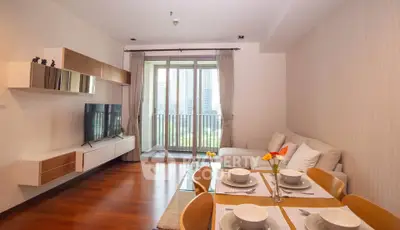 Modern living room with elegant dining area and balcony view