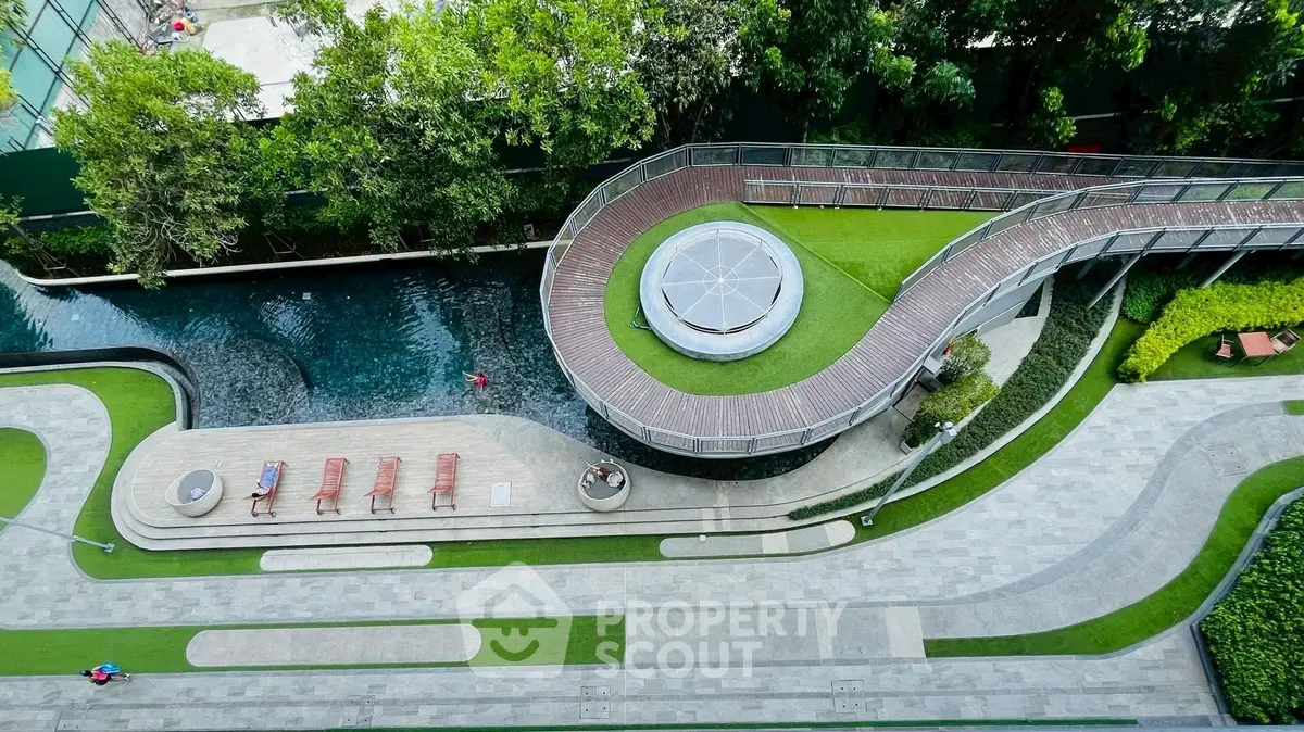 Stunning aerial view of modern building exterior with lush garden and unique architectural design.