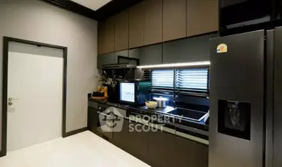 Modern kitchen with sleek black cabinetry and high-end appliances