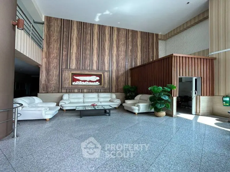 Luxurious lobby with modern decor and plush seating in a high-end residential building.