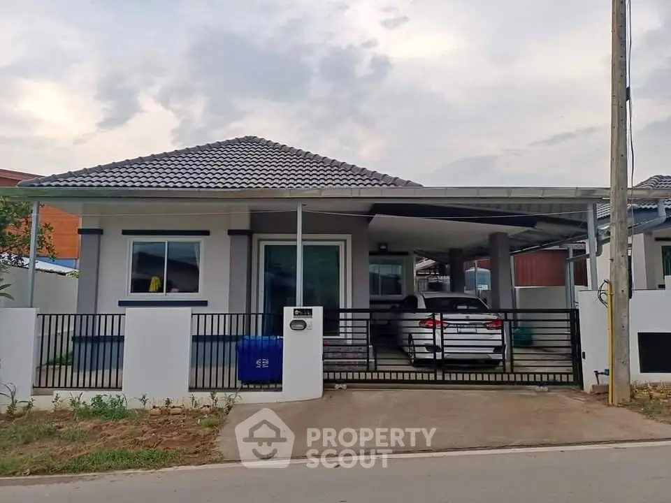 Charming single-story house with carport and modern design in a serene neighborhood.