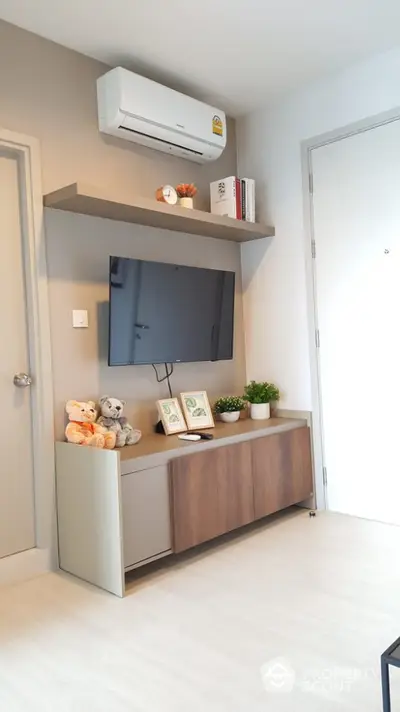 Modern living room with wall-mounted TV and air conditioning unit