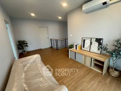 Modern living room with sleek wooden flooring and stylish decor