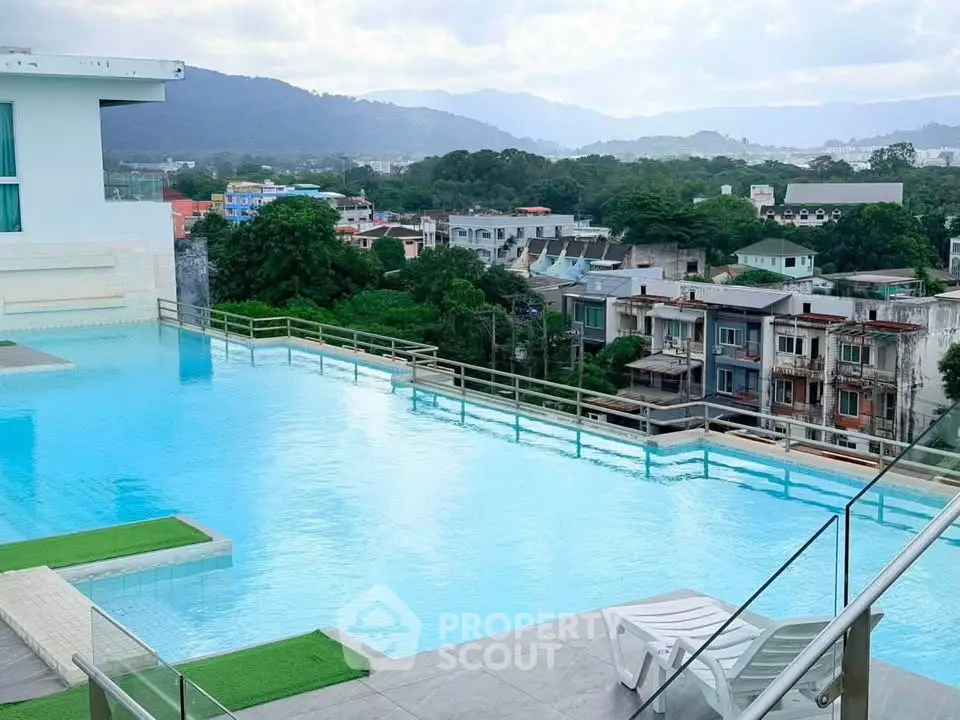 Stunning rooftop pool with panoramic city and mountain views, perfect for relaxation and leisure.