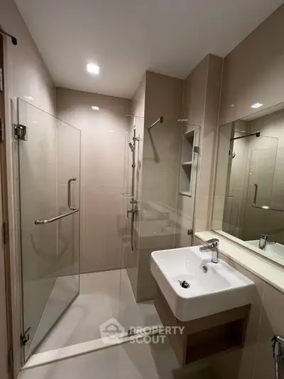 Modern bathroom with glass shower and sleek sink design