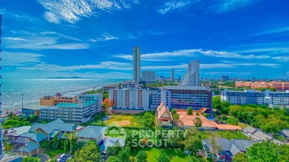 Stunning coastal cityscape with ocean view and modern high-rise buildings.