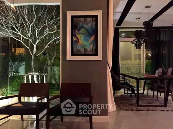 Elegant modern living room with large windows and stylish decor, perfect for entertaining.