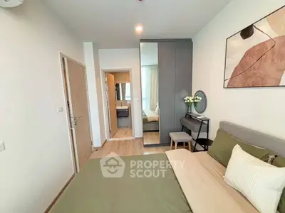 Modern bedroom with stylish decor and ensuite bathroom in a contemporary apartment.