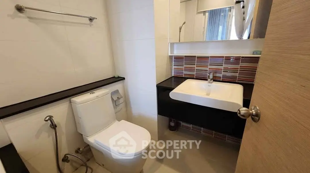Modern bathroom with sleek fixtures and stylish tile backsplash