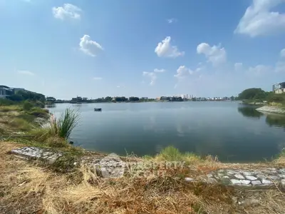 Stunning lakeside view with clear blue sky and serene surroundings, perfect for tranquil living.