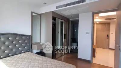 Modern bedroom with elegant design and ample natural light, featuring a stylish headboard and sleek flooring.