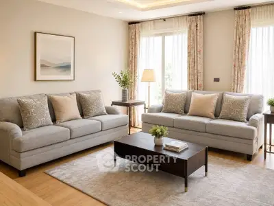 Elegant living room with stylish sofas, coffee table, and large windows with natural light.
