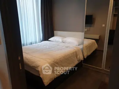 Cozy modern bedroom with mirrored wardrobe and wall-mounted TV