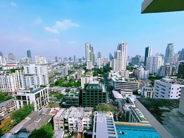 Stunning cityscape view from a high-rise balcony showcasing urban skyline and vibrant city life.