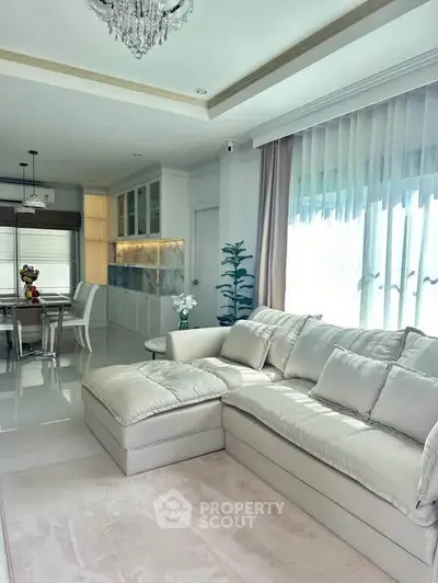 Luxurious living room with elegant sofa and dining area in modern open layout apartment.
