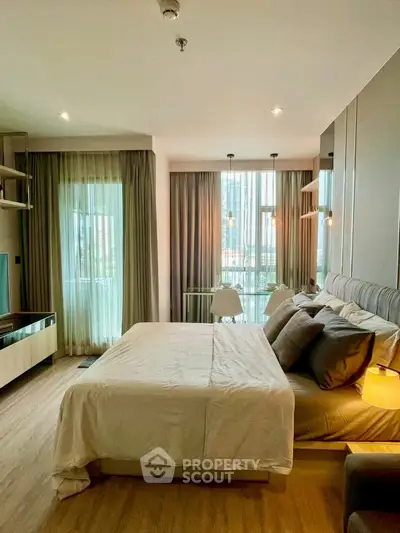 Modern bedroom with large windows and stylish decor in a luxury apartment