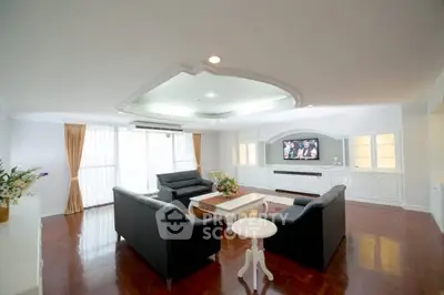 Spacious living room with elegant decor and ample natural light