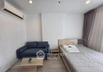 Modern bedroom with cozy sofa and stylish decor in a bright apartment.