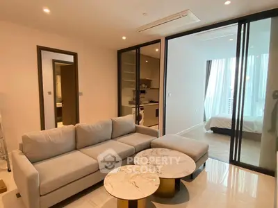 Modern living room with glass partition and cozy sofa in luxury apartment