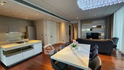 Luxurious open-plan living room and kitchen with elegant dining area and modern decor.