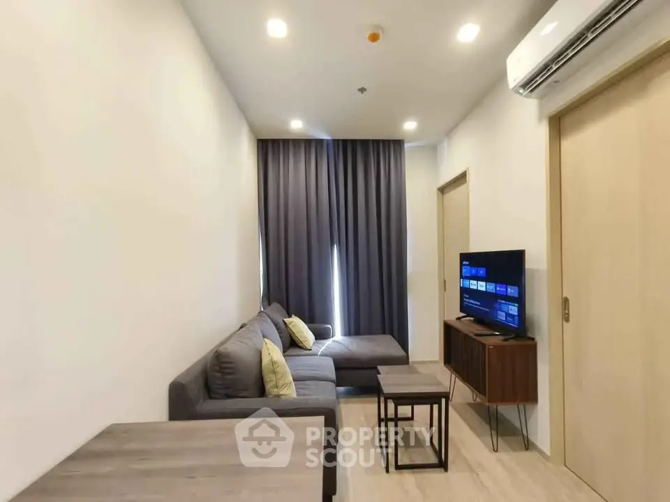 Modern living room with sleek furniture and ambient lighting, perfect for relaxation and entertainment.