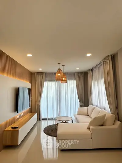 Modern living room with elegant decor and large windows for natural light