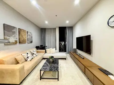 Modern living room with stylish decor, cozy seating, and wall-mounted TV in a contemporary apartment.