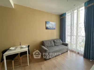 Cozy living room with sofa, dining table, and large window with city view.