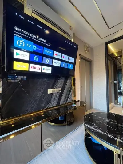 Luxurious living room with modern entertainment setup and sleek marble accents.