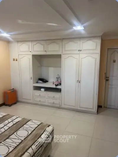 Spacious bedroom with built-in wardrobe and modern decor