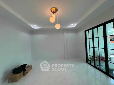 Spacious modern living room with elegant lighting and large glass doors.