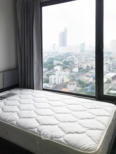 Spacious bedroom with stunning city view from large window