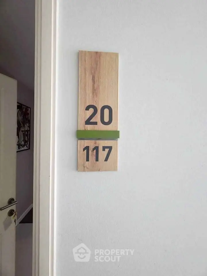 Modern apartment door with stylish room number plaque, showcasing contemporary design and elegance.