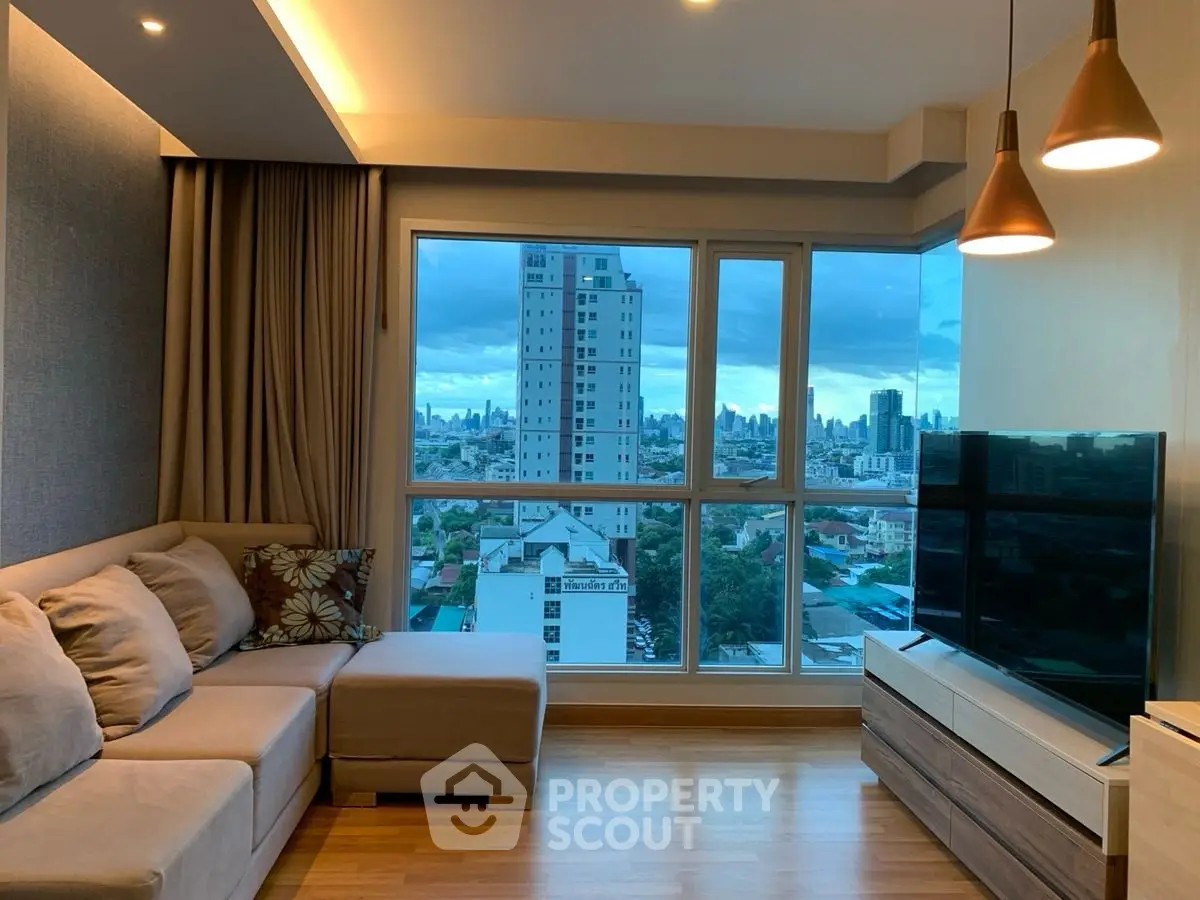 Modern living room with city view, cozy sofa, and stylish lighting.