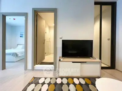 Modern apartment interior with TV, bedroom, and bathroom view