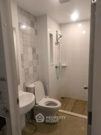 Modern bathroom with stylish tiles and walk-in shower in a contemporary home.