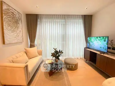 Elegant living room with modern decor, large window, and cozy seating area, perfect for relaxation.