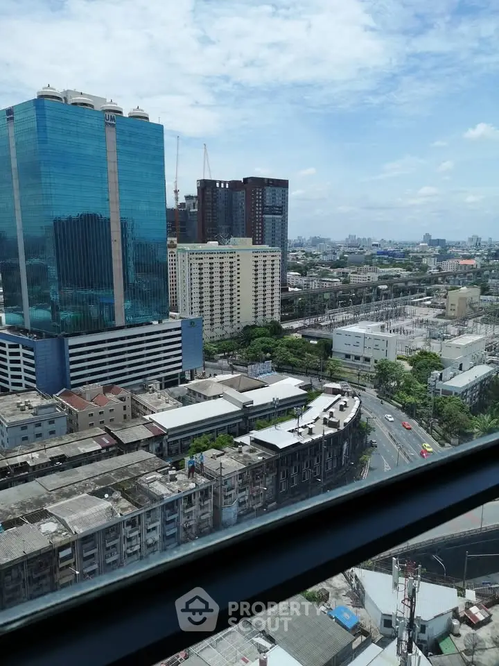Stunning cityscape view from high-rise building window showcasing urban skyline and blue skies.
