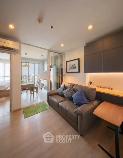 Modern living room with cozy sofa and open kitchen layout in a stylish apartment